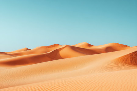 This image presents a desert landscape showcasing rolling sand dunes under a vibrant blue sky. It evokes tranquility and vastness.の素材