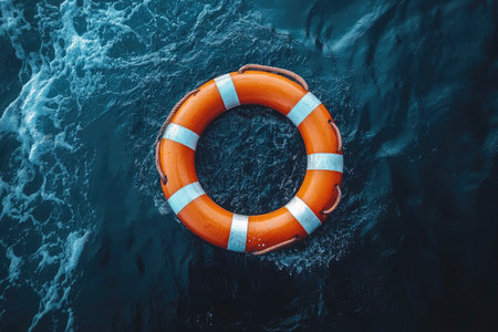 A life ring floating on the sea, with dark blue water in the background. The scene is captured from above, focusing on an orange and white striped combination of a large circular-shaped lifeline attached to it by a rope hanging down. It appears centered against the deep ocean backdrop, creating a sense of calmness and safety. This visual representation conveys swimming or rescue themes, emphasizing the importance of safety and protection during aquatic activities. --ar 3:2 --stylize 750 --v 6.1 Job ID: 0dabe8a6-8bd0-4326-bfc9-dbff895bf861の素材