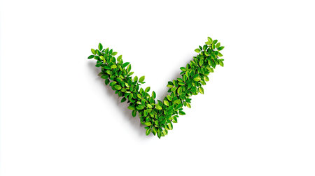 Green check mark symbol is formed by arranging small leaves against a white background. The leaves are vibrant and full of life and detail, creating a simple yet striking visual image.の素材