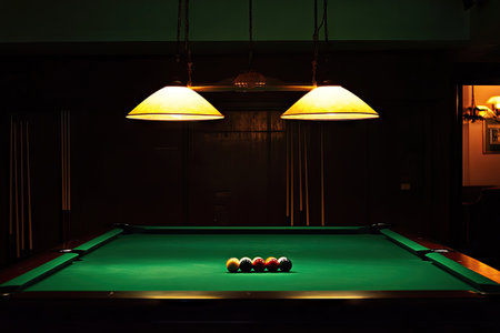 Pool table, set within a dimly lit room.  Two pendant lights illuminate the table, casting a warm glow over the green surface.  The room's walls and furnishings are dark, enhancing the ambiance.の素材