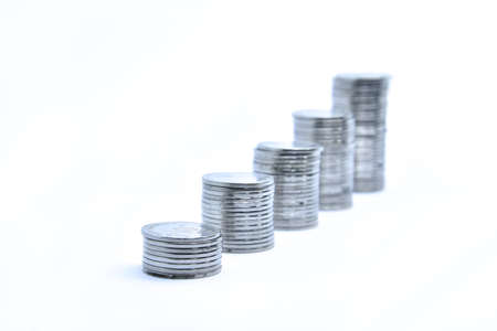 pile of silver coins stack and growing money graph on rows, isolated on white background with clip...