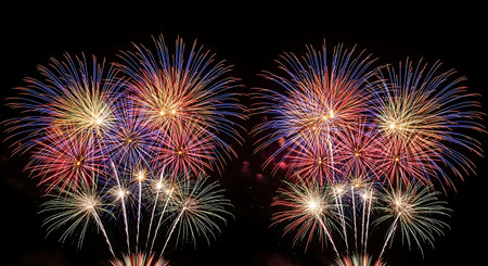 A vivid festival of rockets and fountains lighting up a dark sky with red, blue, green, and gold bursts. Perfect for celebrations, holidays, nightlife, and event promotion visuals.の素材