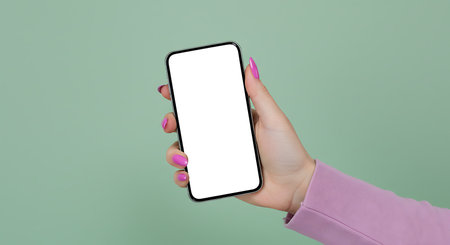 Female hand holding smartphone with isolated screen over green background, mockupの素材