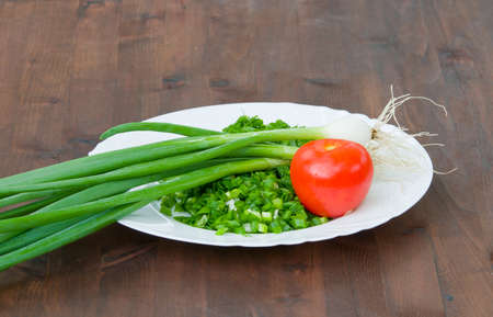 fresh vegetables on the plate  Red tomatoes with green onion の写真素材