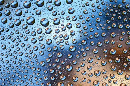 Colored Water Drops on a smooth glass surfaceの写真素材