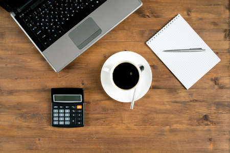 laptop and office supplies laying on the board.の写真素材