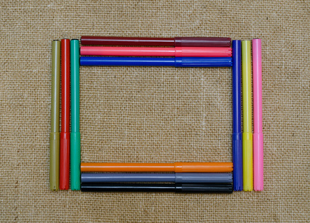 Background colored markers on burlap frame shapedの写真素材