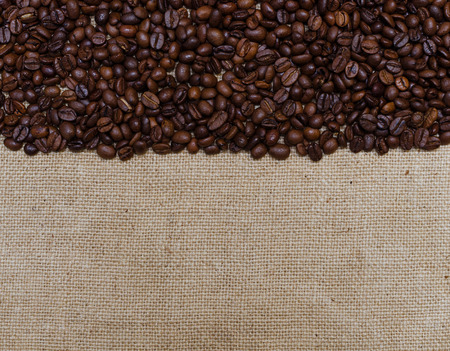 Background coffee beans on burlap half of frame shaped.の写真素材