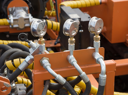 Hydraulic tubes, fittings and levers on control panel of lifting mechanismの写真素材