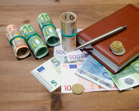 Euro Money, pen and notebook on the tableの写真素材