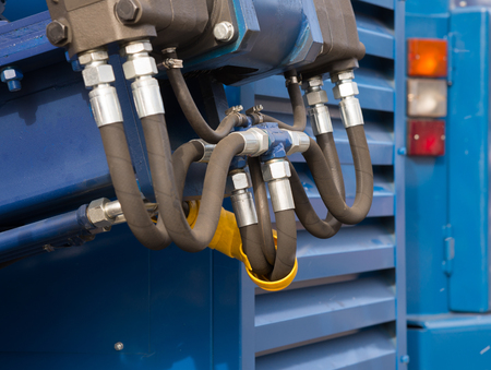 Hydraulic tubes, fittings and levers on control panel of lifting mechanism