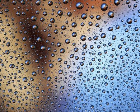 Colored Water Drops on a smooth glass surfaceの写真素材