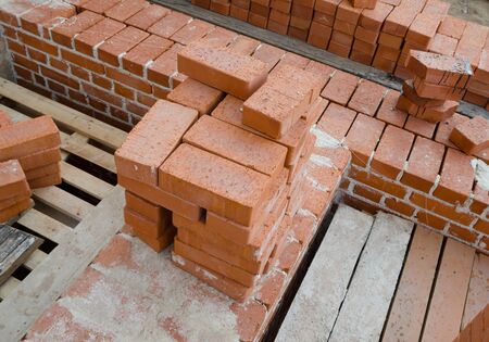 Mason bricklaying background with clay brick blocks
