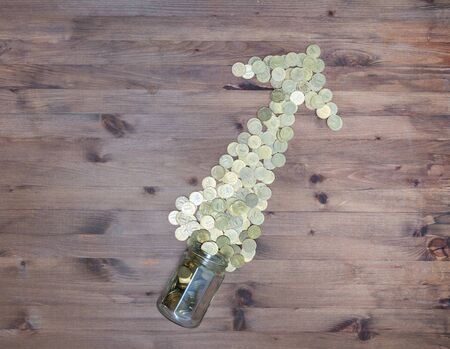 Business Abstract background. gold coins arrow on  wooden table