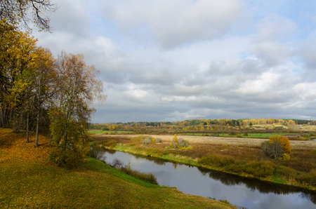view to river with reflections and blue cloudy skyの写真素材