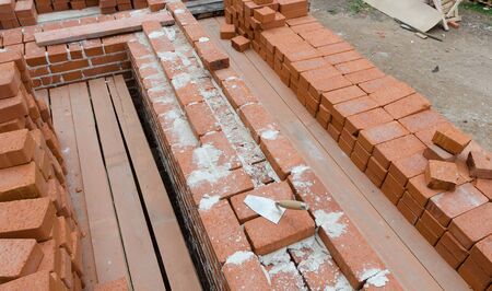 Mason bricklaying background with clay brick blocksの写真素材