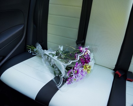 dahlias bouquet on car rear leather seatの写真素材