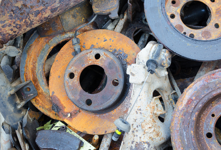 Useless, worn out rusty brake discs shock absorber and other partsの写真素材