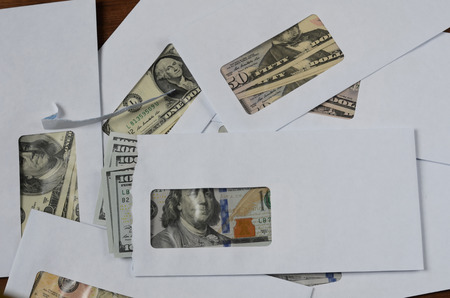 American dollars in envelopes on wooden tableの写真素材