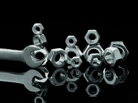 Wrench and nuts on black reflection backgroundの写真素材
