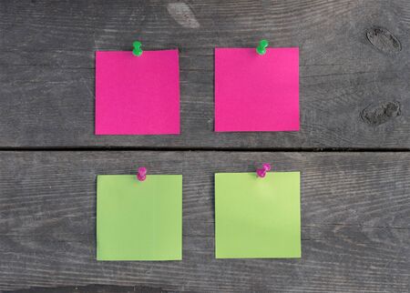 purple and green stickers on old wooden wall