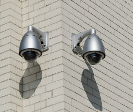 CCTV Security Cameras. Security cameras mounted on the outdoors brick wallの写真素材