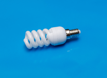 modern energy saving  lamp on turquoise background.