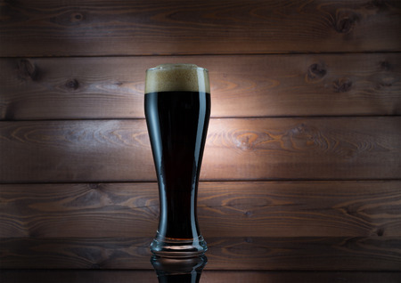 Glasses of dark beer on wood backgroundの写真素材