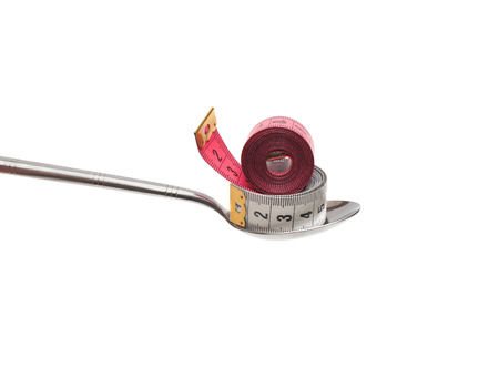 Diet concept. spoon and measuring tape isolated on white background