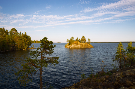 View on island in sea and sky with dark clouds at sunset.の写真素材