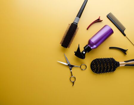 Top view of professional hair dresser tools on yellow backgroundの写真素材