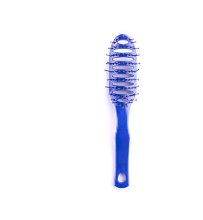 Hairbrush isolated. Blue plastic comb on white background. Hair comb closeup. Everyday hairstyle equipment. Hygiene and care instrument itemの写真素材