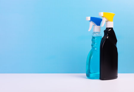 Plastic bottles for cleaning spray gun on blue background.の写真素材