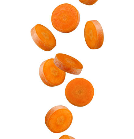 Perfectly retouched round slices of carrots flying in the air isolated on white background.