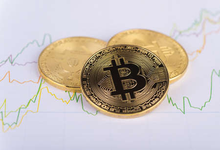 Crypto currency bitcoins on chart of exchange rates