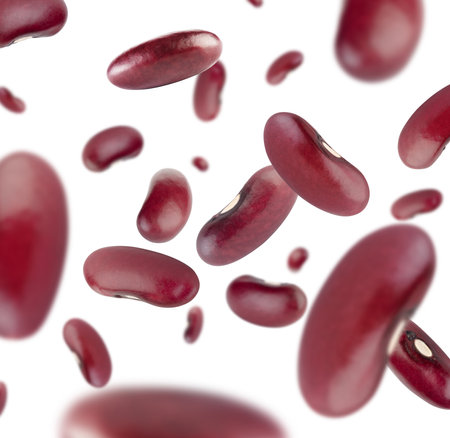 Perfectly retouched dark red beans fly in space. isolated on whiteの写真素材