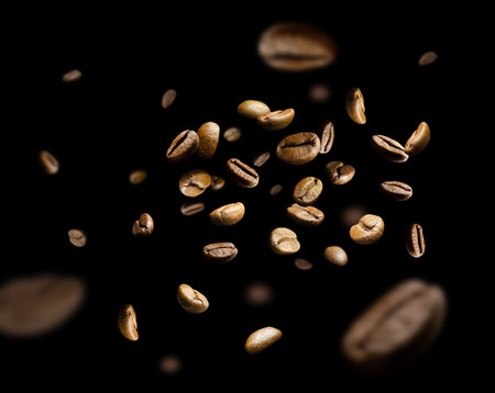 Coffee beans fly and levitate in space. isolated on blackの写真素材