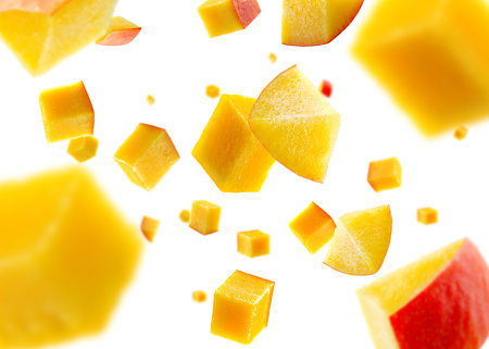 Mango cubes fly and levitate in space. Volumetric light from behind. Isolated on white.の写真素材