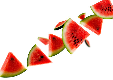 Pieces of watermelon fly in space forming the shape of a chain. Isolated on whiteの写真素材