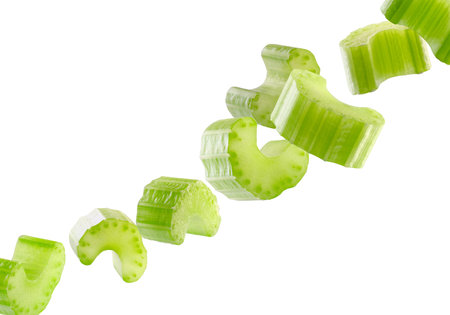 Pieces of celery fly in space forming a chain shape. Isolated on whiteの写真素材