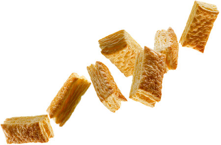 Rectangular puff pastry pies fly in space forming a chain shape. Volumetric back light. Isolated on whiteの写真素材
