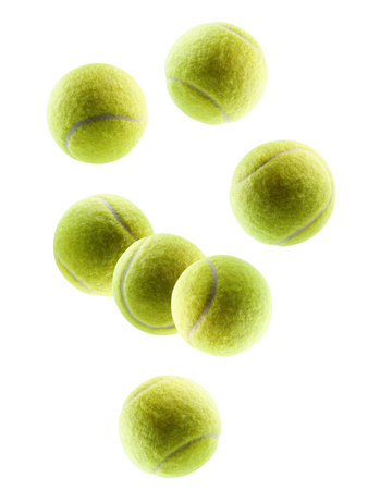 Beautifully retouched tennis balls fall in space. Volumetric back light. Isolated on white.の写真素材