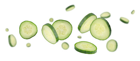 Sliced cucumbers fly and levitate in space. Isolated on whiteの写真素材