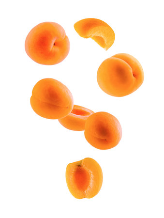 Ripe apricots, whole halves and quarters form an abstract figure in space. Isolated on white.の写真素材