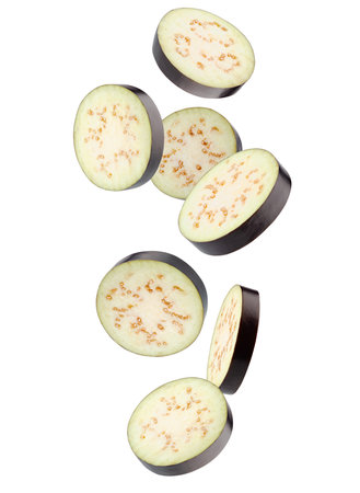 Sliced pieces of eggplant fall in space. Isolated on whiteの写真素材