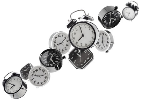 Beautifully retouched different alarm clocks fly in space forming a chain shape. Isolated on whiteの写真素材
