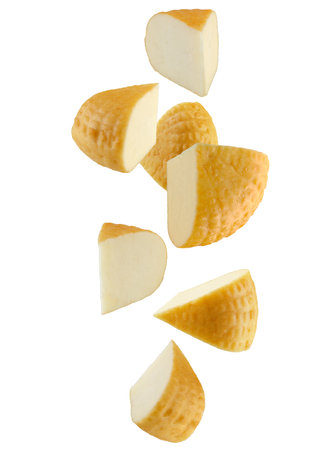 Pieces of smoked cheese falling in space. Isolated on white.の写真素材
