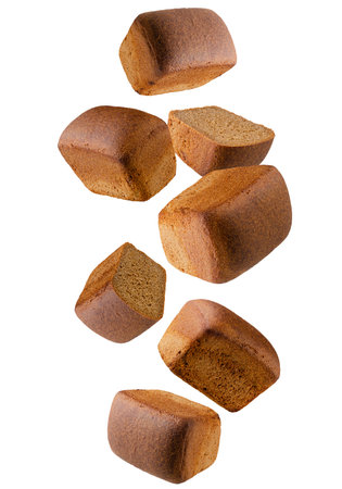 Dark rye bread whole and halves falling in space. Isolated on white. Volumetric back light.の写真素材