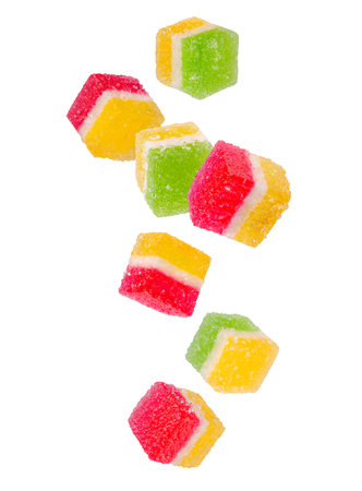 Double colored candied fruit sugar glazed falling in space. Isolated on whiteの写真素材