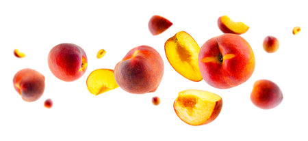 Excellently retouched ripe peaches whole halves and quarters fly in space forming an unusual figure similar to a loop. Isolated on whiteの写真素材